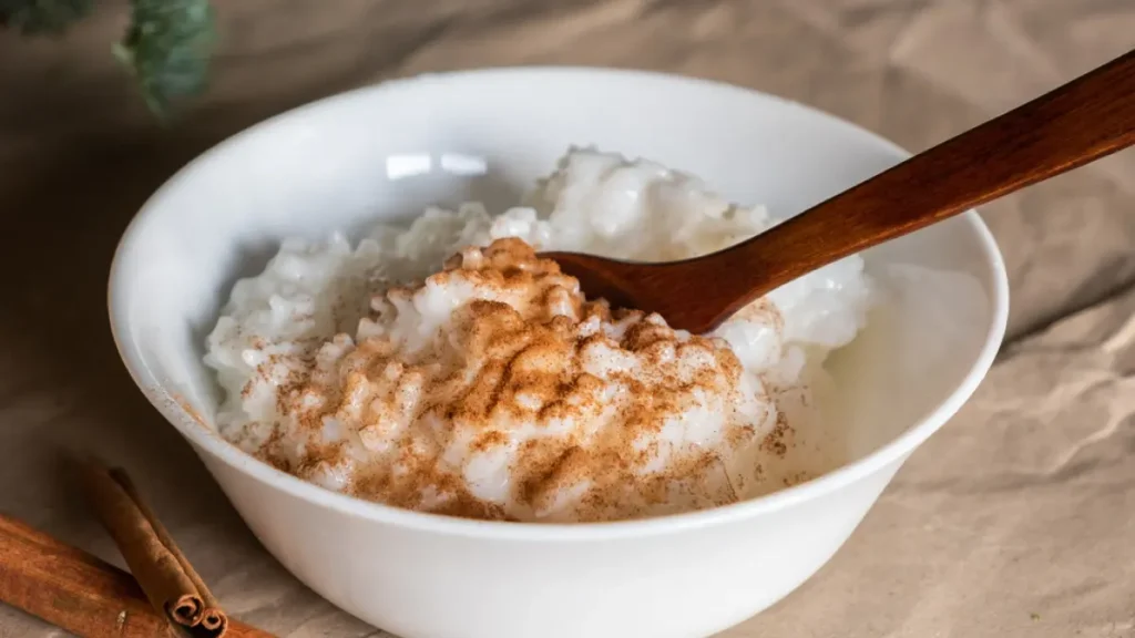 Arroz doce cremoso em tigela branca com canela por cima