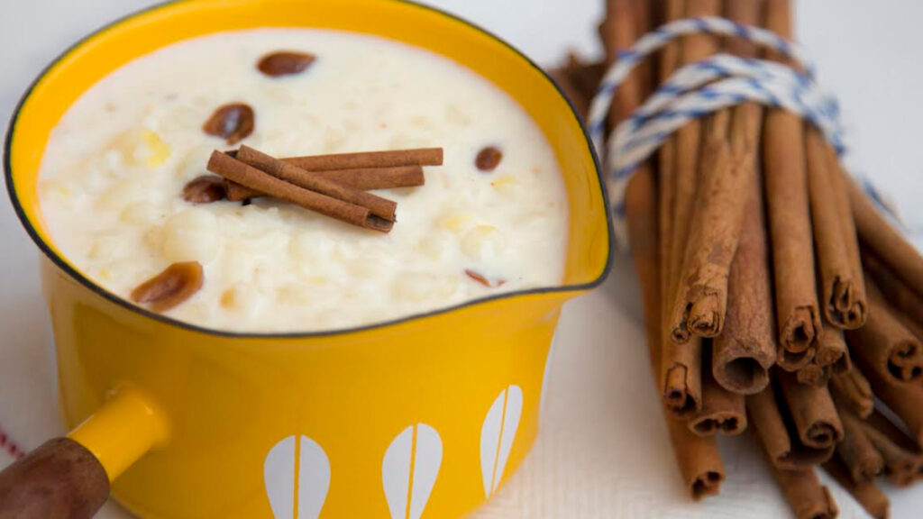 Mungunza ou canjica doce servido em caneca de ágata e decorado com canela em pau