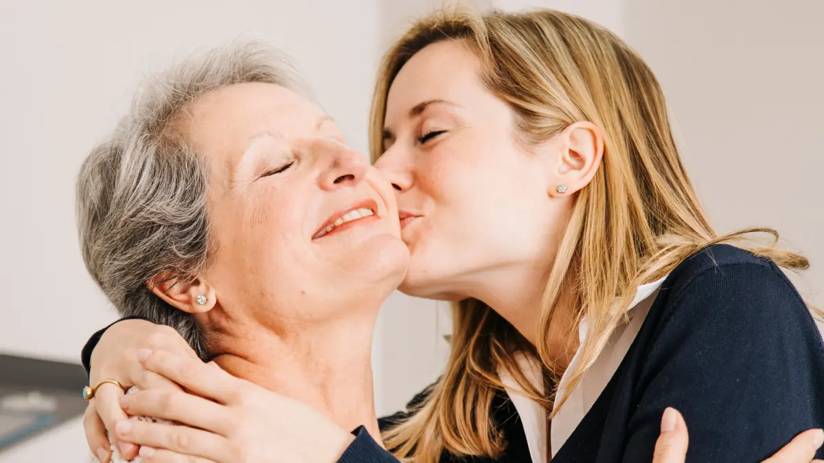 Filha beijando mãe no rosto no Dia das Mães
