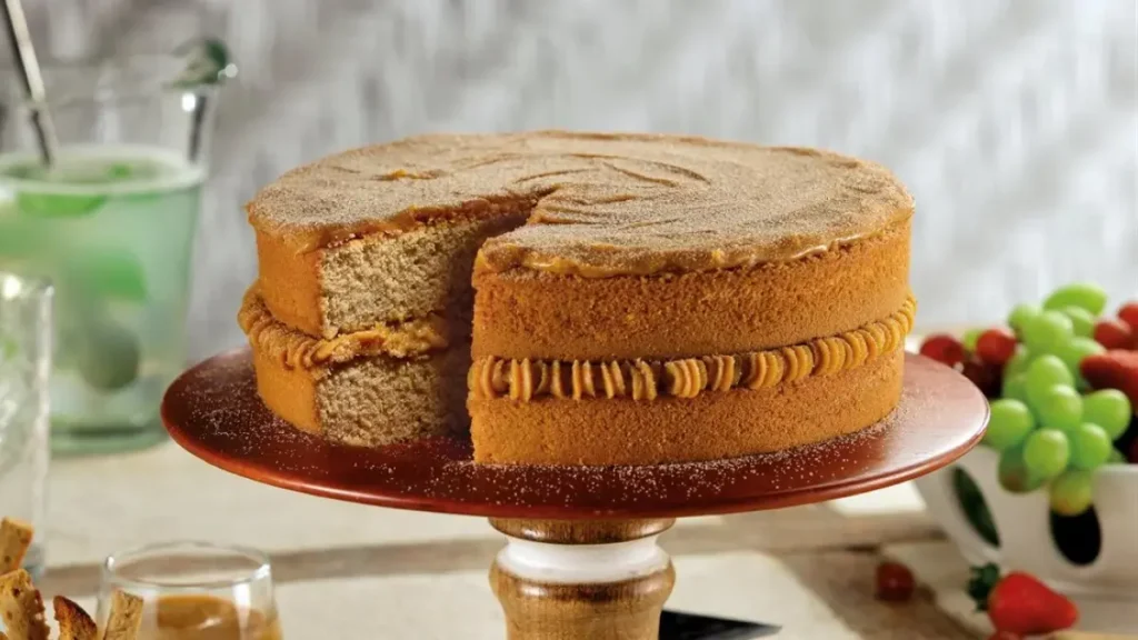 Bolo de churros com doce de leite e açúcar e canela polvilhados.