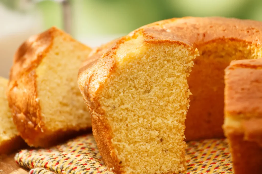 Bolo de milharina inteiro e cortado em uma fatia.